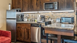 A kitchen with wooden cabinets, stainless steel appliances, a microwave, toaster, and a dishwasher. - Cozy stay for 4: 5 Min Drive to Base,  Full Kitchen, Shared Hot Tub & Pool, Restaurants Nearby! (Park City)