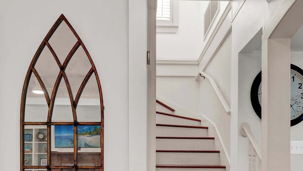 A staircase with wooden steps and white walls.