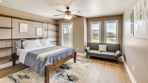 A bedroom with a bed, a ceiling fan, and a sofa. - 11 Mi to Dtwn: Lubbock Home w/ Patio, Grill & Yard (Lubbock)
