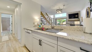 A modern kitchen with granite countertops, stainless steel appliances, and a built-in oven. - 7 Mi to Dwtn - Family Condo in Harbor Springs! (Harbor Springs)