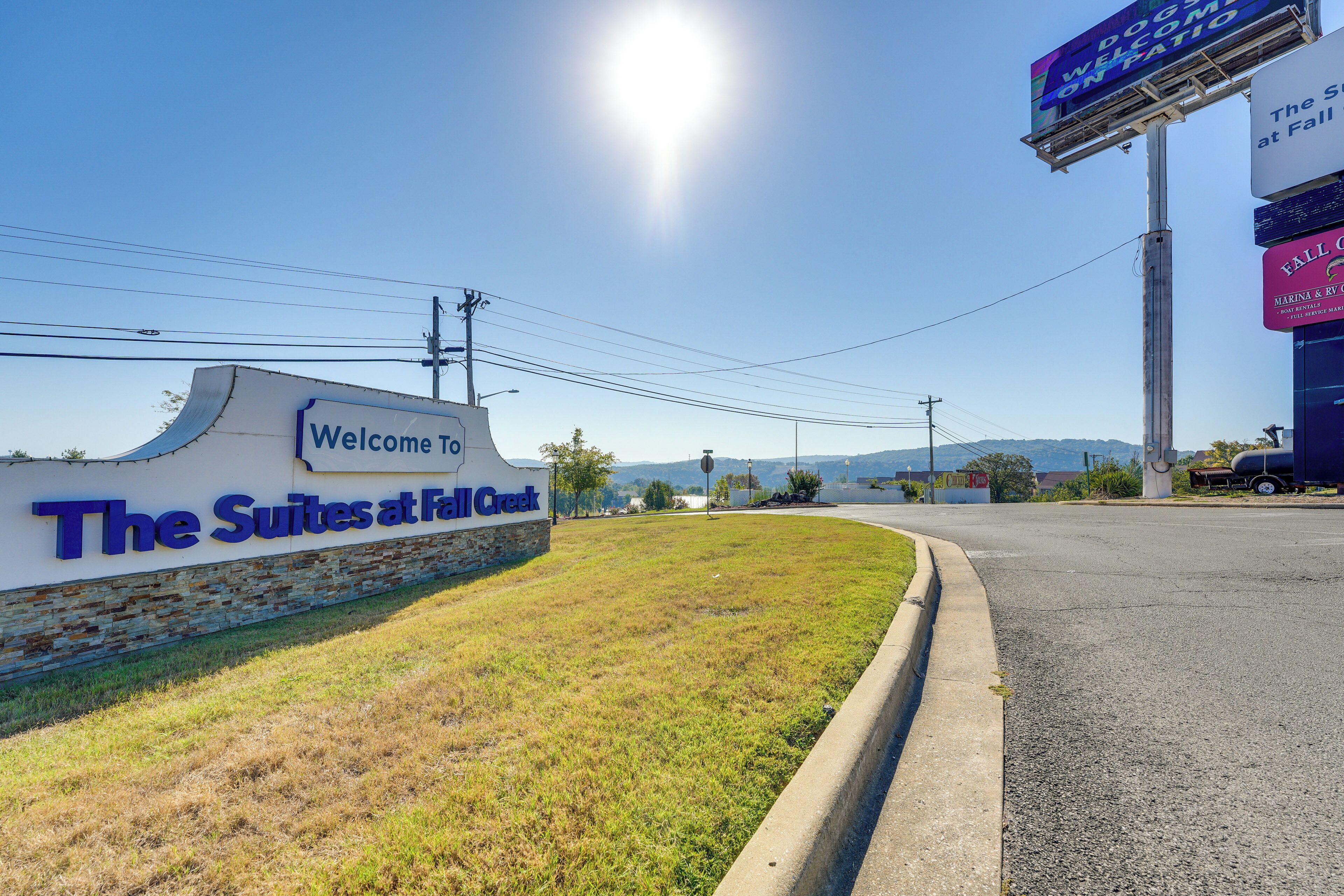 A hotel entrance with a sign reading "Welcome to The Suites at Fall Creek."
