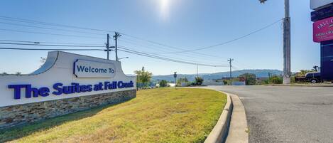 A hotel entrance with a sign reading "Welcome to The Suites at Fall Creek."