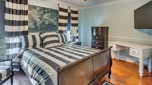 A bedroom with a bed, a dresser, a desk, and a ceiling fan. - Walk to Ocean & Dtwn: Myrtle Beach Townhome! (Myrtle Beach)