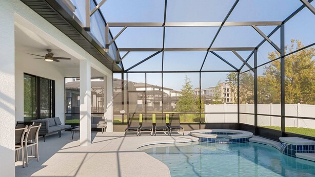 A modern indoor pool area with a glass ceiling, seating, and a hot tub. - 5911 Luxury 10bd Family Home For an Unforgettable Vacation (Orlando)