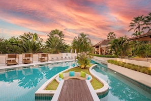 A pool area with lounge chairs and a wooden deck. - Dewa Phuket - Pool Villa (Sa Khu)