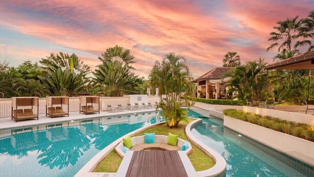 A pool area with lounge chairs and a wooden deck. - Dewa Phuket - Deluxe Garden (Sa Khu)