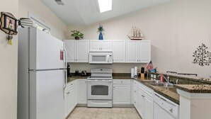 A kitchen with white cabinets, a refrigerator, a microwave, an oven, and a dishwasher. - Ocean Keyes 2242- 2BR/2BA-Close to Main St (North Myrtle Beach)