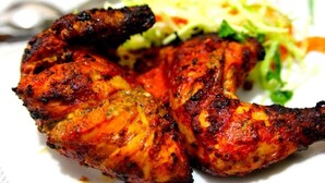 Grilled chicken wings with a side of coleslaw.