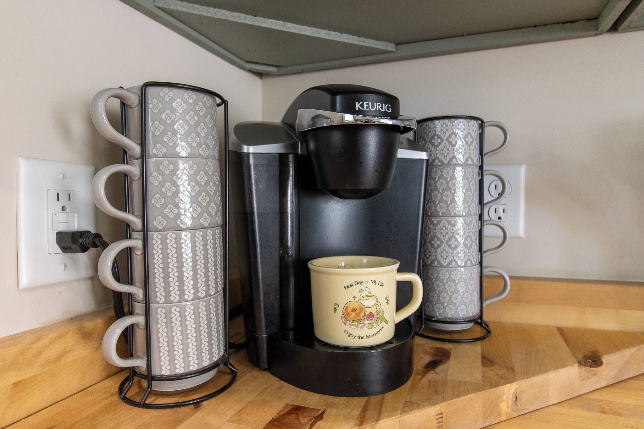A coffee maker with a mug on the counter.