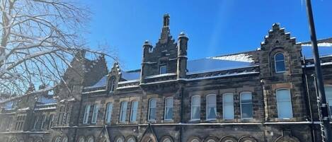 A historic building with arched windows and a stone facade.