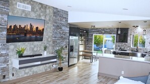 A modern kitchen with a built-in island, stainless steel appliances, and a large cityscape painting on the wall. - Charming 2-bedroom house in fantastic Las Vegas with AC, WiFi Casita los Hermano (Las Vegas)