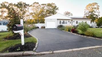 A residential driveway leading to a house with a mailbox.