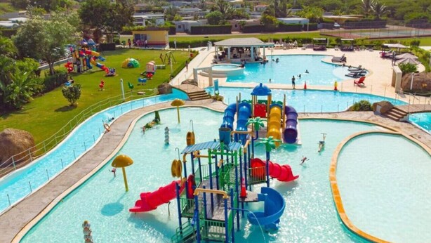 A water park with multiple pools, slides, and play structures.