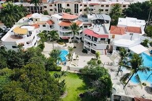 Experience tropical luxury with our hotel's multiple pools surrounded by lush greenery and palm trees.