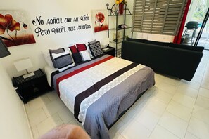 Relax in this serene bedroom with a comfortable bed, sofa, and stylish nightstand.