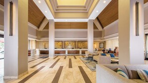 A spacious lobby with a central reception desk, comfortable seating areas, and a modern ceiling design. - Marriott Desert Springs Villas 2B/2B Thanksgiving 11/23-30,26  FullResort Access (Palm Desert)