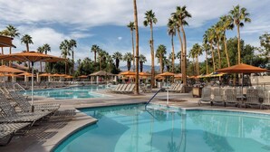 A pool area with lounge chairs and umbrellas, surrounded by palm trees. - Marriott Desert Springs Villas 2B/2B Thanksgiving 11/23-30,26  FullResort Access (Palm Desert)