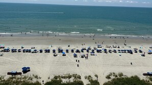 A beach with umbrellas and people. - Spacious Oceanfront 2-bedroom Condo in Bay Watch in beautiful North Myrtle Beach (North Myrtle Beach)