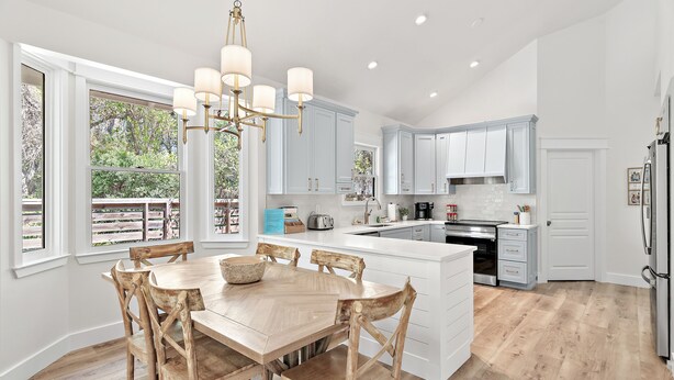 A spacious kitchen with a large island, white cabinetry, and a chandelier. - Pools*Bikes*Pools*Walk2beach (Santa Rosa Beach)
