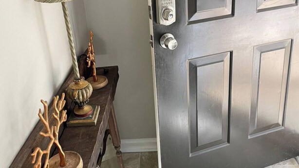 A dark gray door with a keyhole and a doorbell. - Down Home Comfort - Greenville, SC

 (Piedmont)