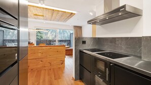 A modern kitchen with a large island, stainless steel appliances, and a view of the outdoors. - Apartment 'Paradeis Apartments A19' with Mountain View, Private Terrace and Wi-Fi (Mühlbach)