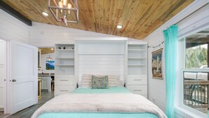 A bedroom with a bed, white walls, a wooden ceiling, and a window with a view. - Welcome Hunters! Next to Garrity Mtn Wildlife Area (Anaconda)
