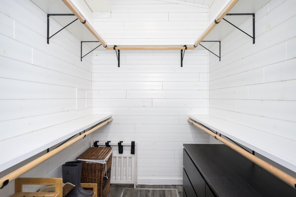 A narrow, white-paneled room with a radiator, a black cabinet, and wooden shelves. - Welcome Hunters! The Aspens are Changing Colors (Anaconda)