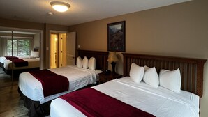 A hotel room with two beds, a wooden headboard, a lamp, and a painting on the wall. - Purgatory Townhomes 128, perfect for families in the heart of the Purgatory (Durango)