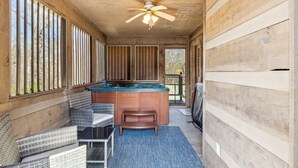 A wooden cabin with a pool table, a ceiling fan, and a view of the outdoors. - Lovey Bear - A Cozy Dog-Friendly Cabin with Hot Tub, Fireplace – Across from Soaky Mountain (Sevierville)