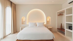 A modern bedroom with a central bed, bedside tables, a wardrobe, and a large window with curtains. - Villa Sari 1 by Alfred in Bali (Pecatu)