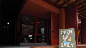 A signboard outside a building with the text "OPEN DAILY KITCHEN & CAFE". - Monder House (Chiang Mai)