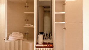 A modern bathroom with a curved vanity, a radiator, and neatly folded towels. - Monder House (Chiang Mai)