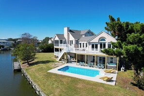 Enjoy a relaxing stay in this two-story house with a spacious backyard featuring a swimming pool, hot tub, and covered patio area.