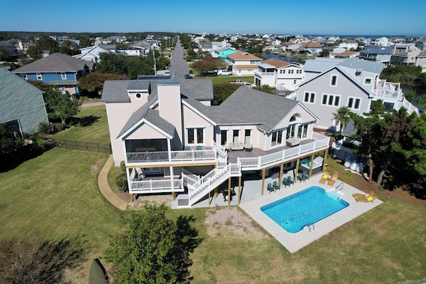 Enjoy a spacious two-story house with a balcony and large backyard, featuring a swimming pool and covered patio.