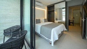A modern bedroom with a large bed, a seating area with chairs, and a glass wall. - SMART APARTMENT - EXTERNAL VIEW (Ipojuca)