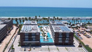 A hotel with a rooftop pool, a beach view, and a parking lot. - SMART APARTMENT - EXTERNAL VIEW (Ipojuca)
