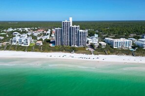 Un hôtel situé sur la côte, composé de plusieurs bâtiments, doté d’une plage et offrant une vue dégagée sur l’océan.