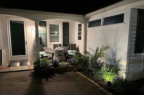 A house with a covered patio, a door, and a window.