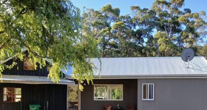 cosy cottage with wood heater, surrounded by bushland