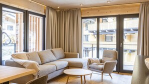 A modern living room with a sofa, chairs, and a coffee table. - Premium Suite mit 2 SZ & Mini-Spa by Interhome (Saalbach-Hinterglemm)