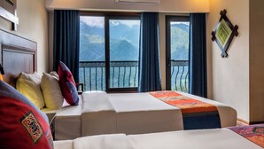 A hotel room with two beds, a balcony with a view of mountains, and an air conditioning unit. - Sapa Charm Hotel (Sa Pa)