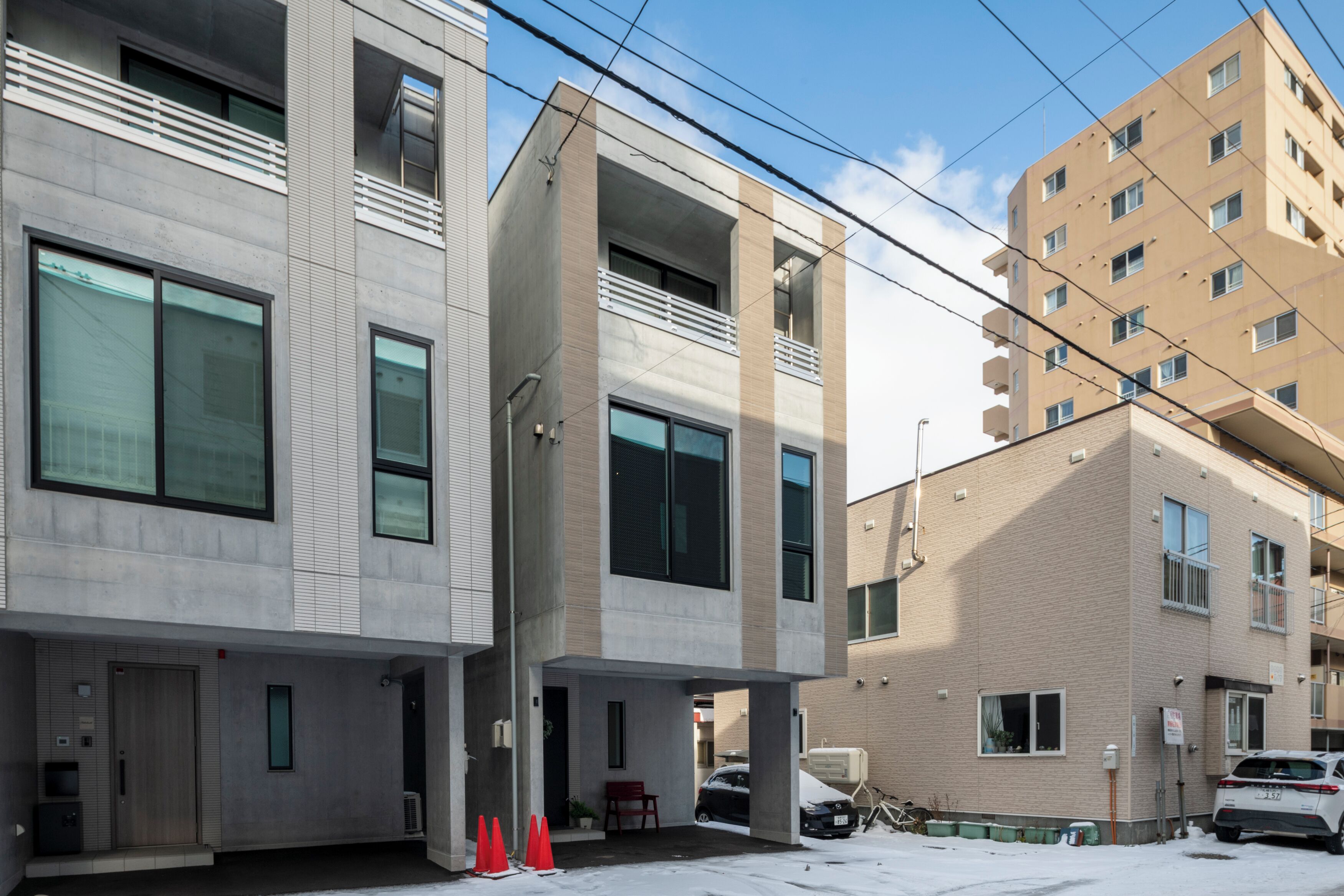 A modern multi-story building with large windows and balconies.
