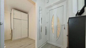 A room with a wardrobe, a door with a unique design, and a black cabinet. - DaLaPaDo by Interhome (Zadar)