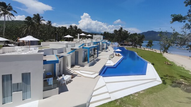 A resort with a swimming pool, outdoor seating, and a view of the beach and ocean. - Recidencia Del Hamor Beachfront (Santa Magdalena)
