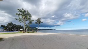 A beach with a clear view of the ocean, palm trees, and a distant island. - Recidencia Del Hamor Beachfront (Santa Magdalena)