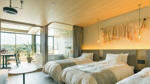 A modern hotel room with two beds, a balcony with a dining table, and a large window offering a view of the landscape. - HOTEL and KOTEI SOKA (Kyotango)