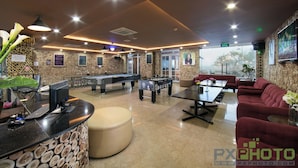 A modern indoor space with a pool table, foosball table, and seating area. - SaPa Signature Inn (Sa Pa)