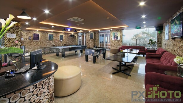 A modern indoor space with a pool table, foosball table, and seating area. - SaPa Signature Inn (Sa Pa)