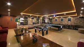 A billiards room with a pool table, a foosball table, and a bar area. - SaPa Signature Inn (Sa Pa)