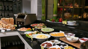 A buffet with various food items including salads, cheeses, and meats. - SaPa Signature Inn (Sa Pa)